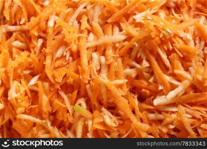 Close up grated carrots vegetables salad as background