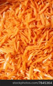 Close up grated carrots vegetables salad as background