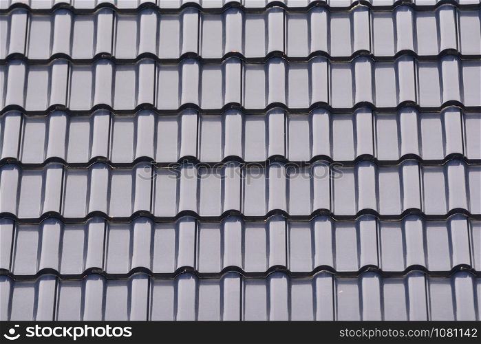 Close up group of gray tiles roof, texture gray background.