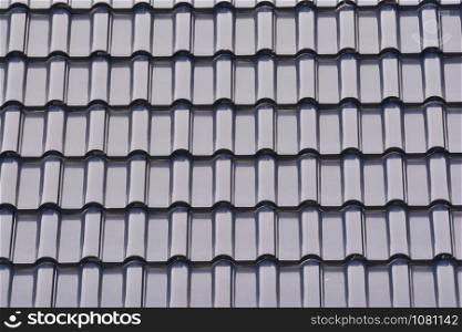 Close up group of gray tiles roof, texture gray background.