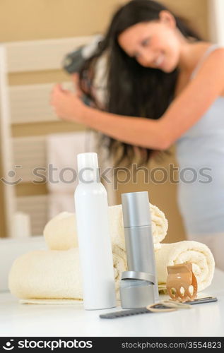 Close-up hair products in bathroom brunette woman drying hair