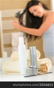 Close-up hair products in bathroom brunette woman drying hair