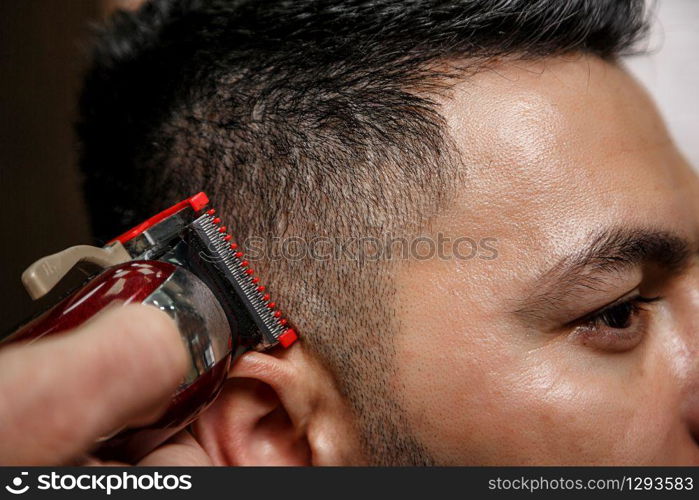 close-up haircut of a dark-haired guy. cinematic photography.