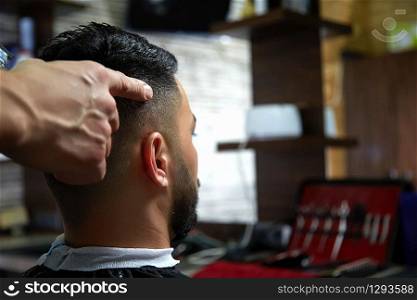 close-up haircut of a dark-haired guy. cinematic photography.