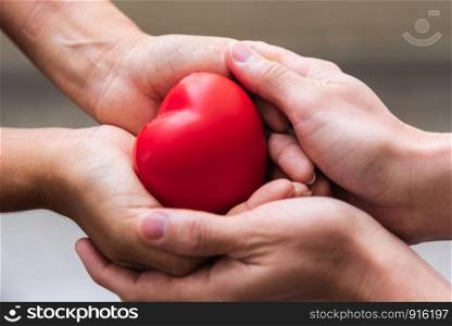 Close up hand giving red heart as heart donor. Valentine day of love concept. Medical ventilator and heart donator charity. Sign of compassion and healthy. Helping doctor hand in freedom life donation