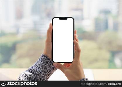 close up hand holding mock-up phone blank screen and cityscape blur background