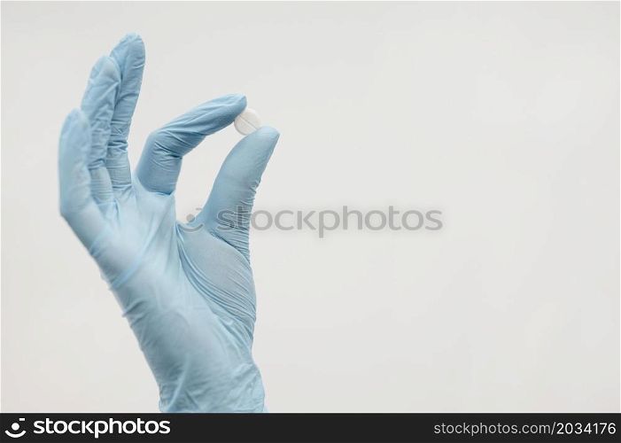 close up hand holding pill with copy space