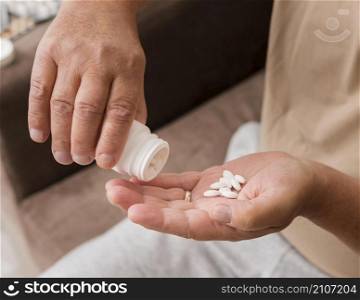 close up hand holding pills