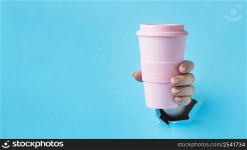 close up hand holding reusable cup with copy space