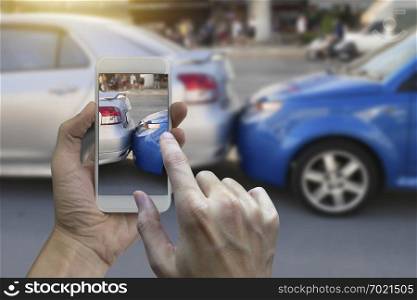 Close up hand holding smartphone and take photo at The scene of a car crash and accident, car accident for car insuranc claim. 