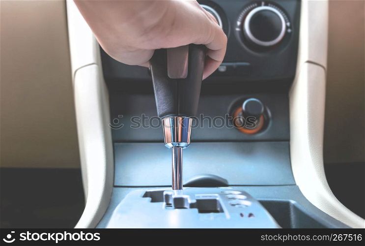 close up hand holding to change the gear inside a car