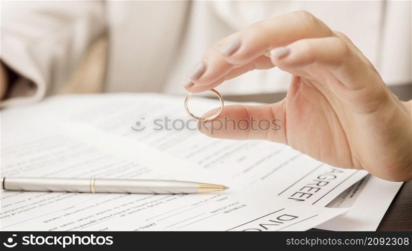 close up hand holding wedding ring