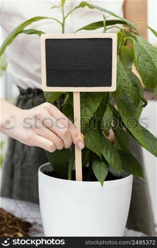 close up hand holding wooden sign