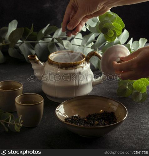 close up hand making tea pot
