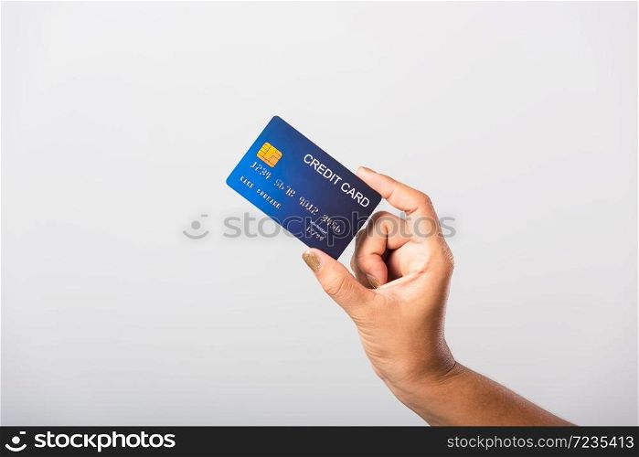 Close up hand of Asian woman she holding bank credit card for pay money online shopping, studio shot isolated on white background