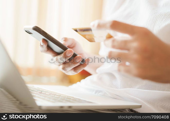 Close up hand of women are buying online with a credit card. woman are using smartphone and doing online transactions.