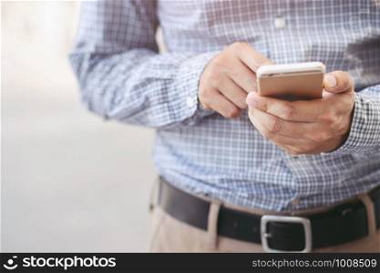 close up hand of young man using mobile smart phone. or Business man Contact Customer. Leave space to write descriptive text.