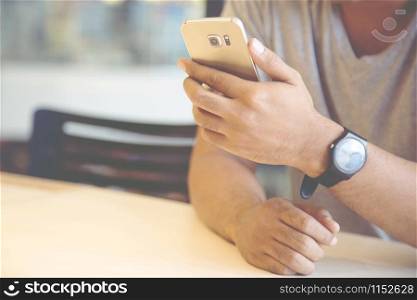 close up hand of young man using mobile smart phone. or Business man Contact Customer. Leave space to write descriptive text.