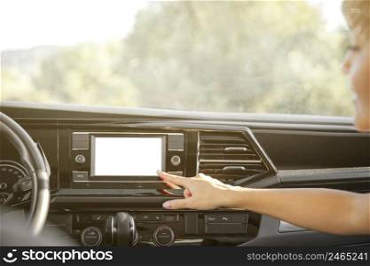 close up hand pointing car radio