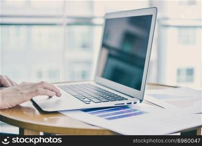 Close up hand touching a laptop in business concept with free sp. Close up hand touching a laptop in business concept with free space. Close up hand touching a laptop in business concept with free space