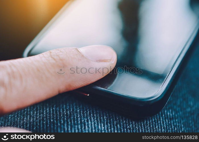 close up hand touching on screen of smartphone,close up people are using smart phone