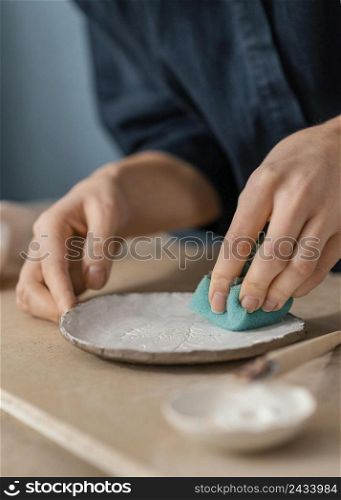 close up hand using blue sponge