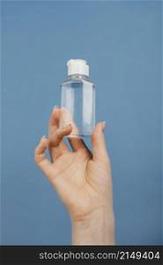 close up hand with hand sanitizer bottle