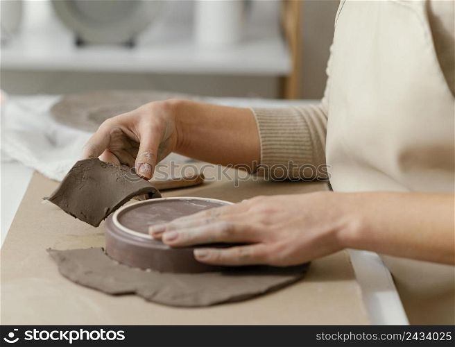 close up hands doing pottery 3