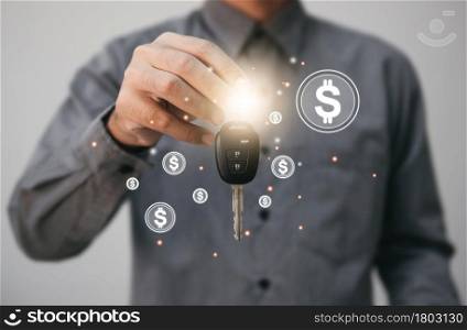 Close up hands holding car keys. man holding key of car giving to agent of Insurance for sell. business investment Insurance Car seizure and car concept.