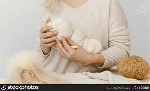 close up hands holding knitting yarns 2