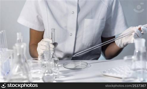 close up hands holding lab glassware