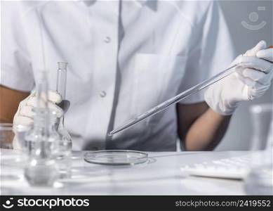 close up hands holding laboratory glassware