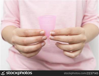 close up hands holding menstrual cup