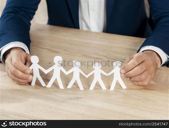 close up hands holding paper people