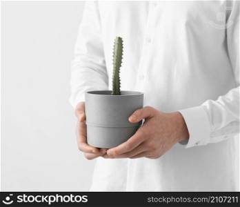 close up hands holding plant pot