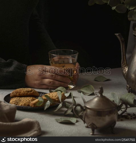 close up hands holding tea glass