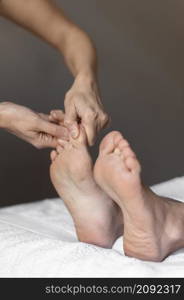close up hands massaging feet