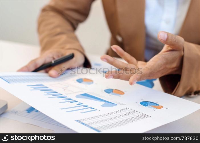 Close up hands of business woman explaining a data marketing.