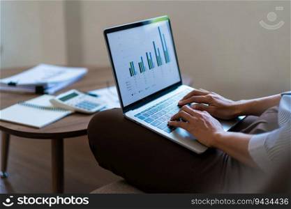Close up hands of businesswoman putting laptop on the legs and typing business data on keyboard.