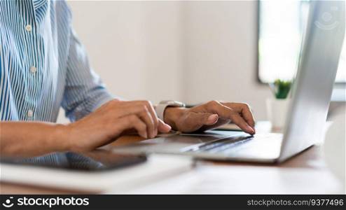 Close up hands of businesswoman typing on laptop keyboard to working and searching business data.