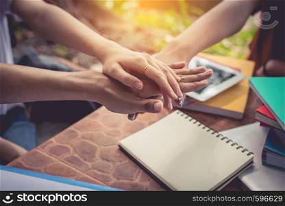 Close up hands of people putting and stacking their hands together. Friendship and Unity concept. Teamwork and Successful concept. Parts of body and Working people theme. Business and Marketing theme.