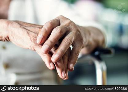 Close up hands of senior elderly woman patient suffering from pakinson?s desease symptom. Mental health and elderly care concept