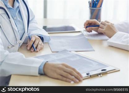Close up hands of two women doctor medical lab discussing together healthcare teamwork. Two asian women hand doctors meeting write prescription medical clinic. Doctor discuss using laptop write note