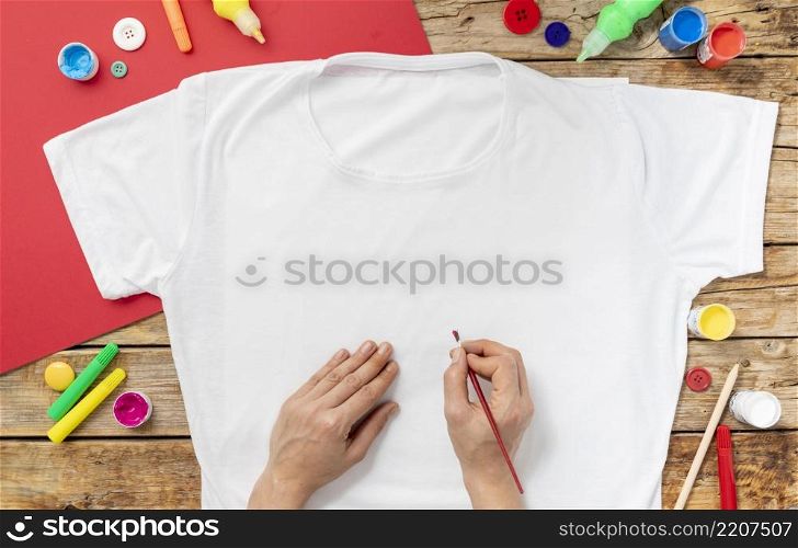 close up hands painting shirt