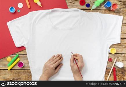 close up hands painting shirt