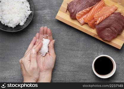 close up hands preparing rice sushi