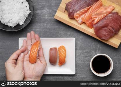 close up hands preparing sushi