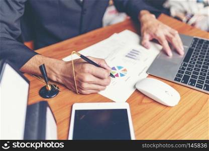 Close up hands signing terms of agreement documents of businessman on his desk, business signing concept