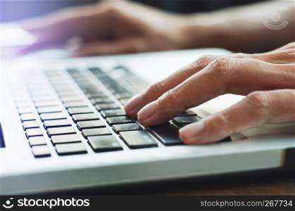 close up hands typing keyboard laptop