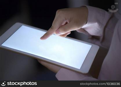 Close-up hands using a tablet with a blank white screen